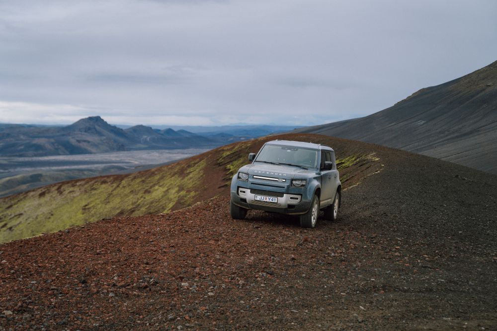 Land Rover Defender 4x4 driving on a volcano crater in Iceland.