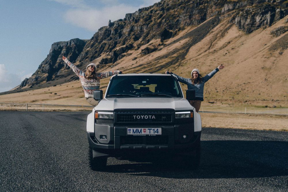 Two women with a large 4x4 rental car in Iceland.
