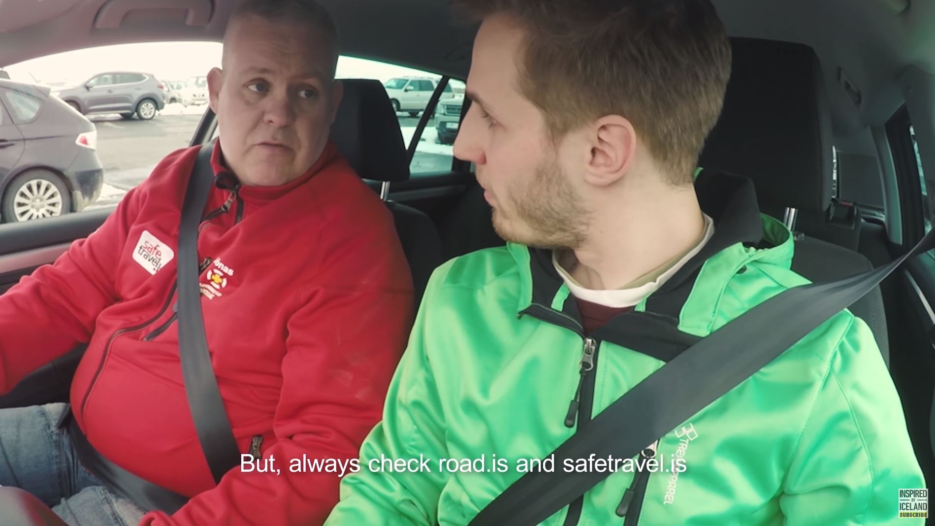 Two men buckled up in a car 