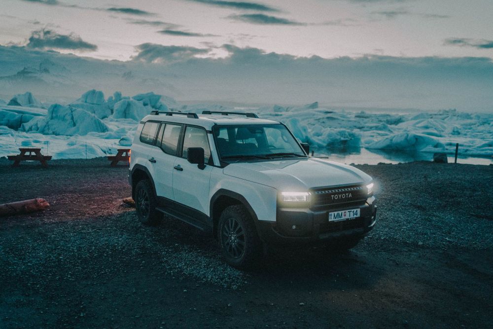Toyota Land Cruiser parked at Jökulsárlón glacier lagoon in Iceland.