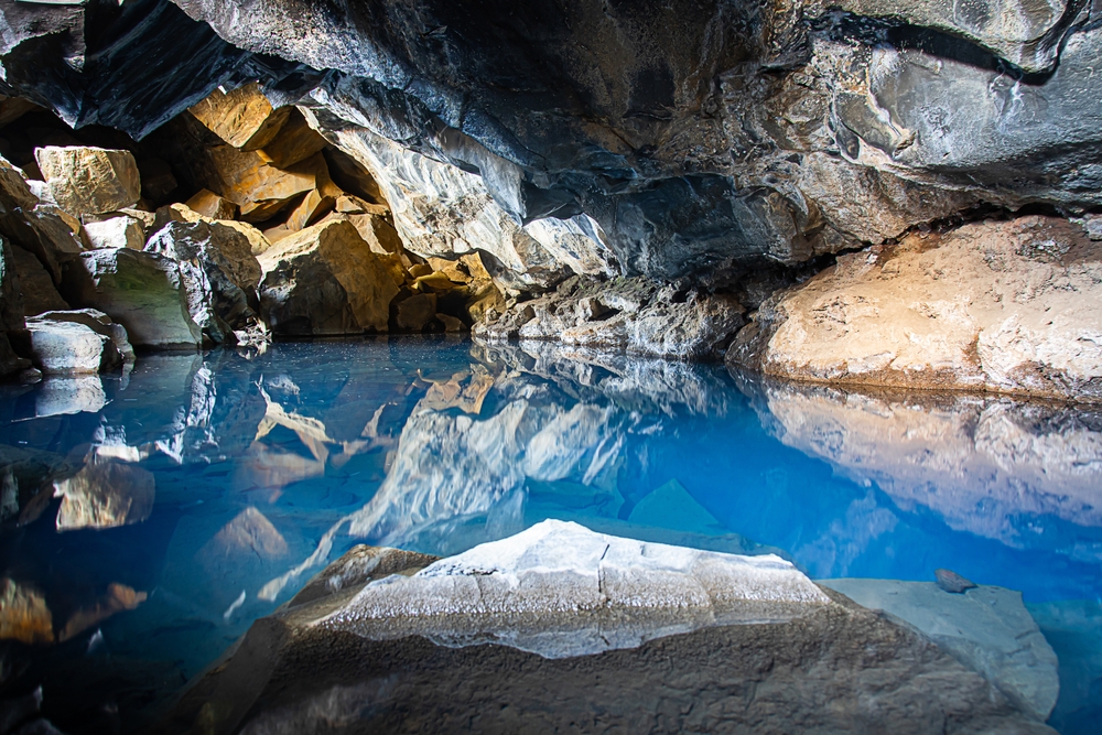 Blue hot spring water inside of Grjótgjá cave in north Iceland. 
