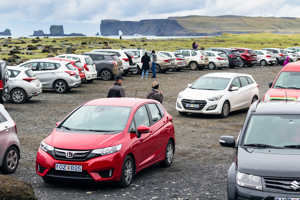 Reynisfjara parking area on Iceland's south coast with Dyrhólaey in the back.